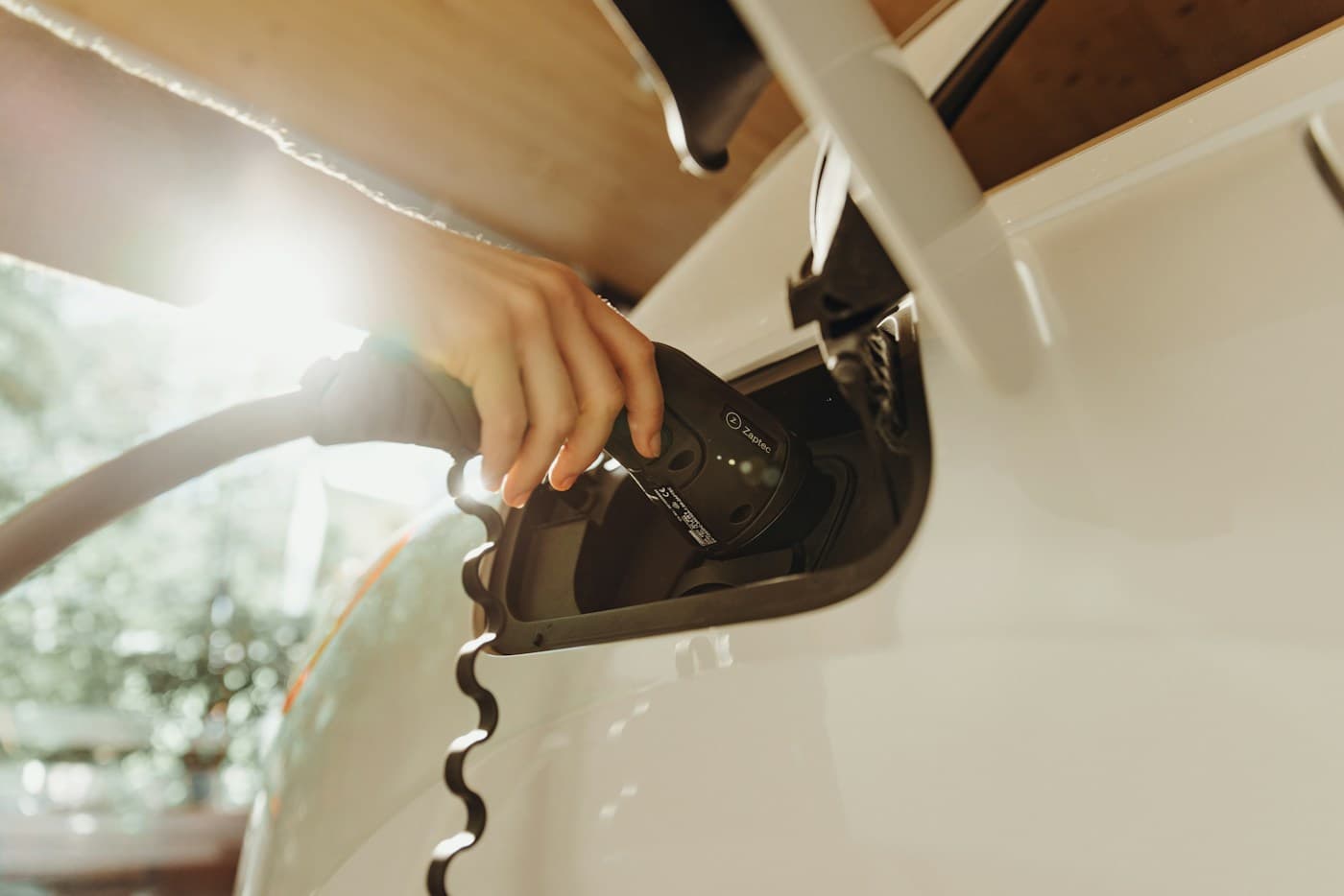 A person connecting an electric car for charging
